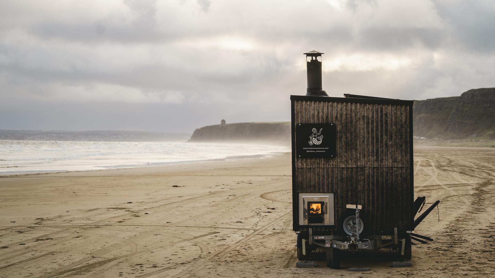 sauna standing on a beach backed by cliffs sauna standing on a beach backed by cliffs