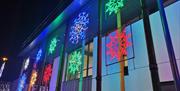 Colourful snowflakes line the side of the Roe Valley Arts & Cultural Centre building