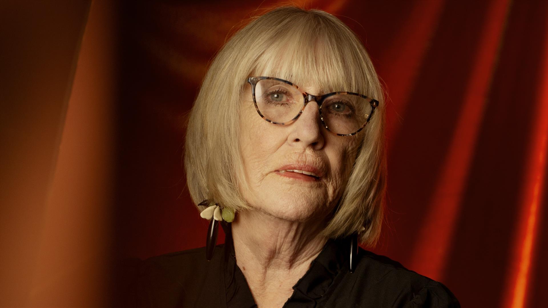 Moyra Donaldson standing in front of a red curtain Moyra Donaldson standing in front of a red curtain