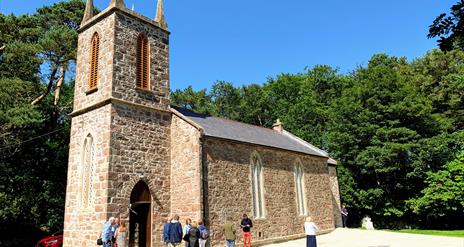 Church in background, people in foreground on a sunny day