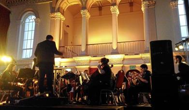 Orchestra playing a room with mood lighting