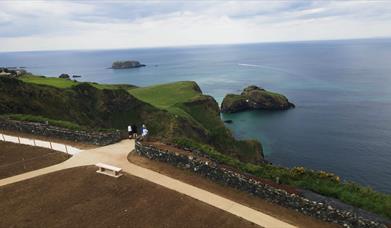 people standing on the viewing platform at Portaneevy View Point. Sheep Island and Carrick a rede island can be seen in the background