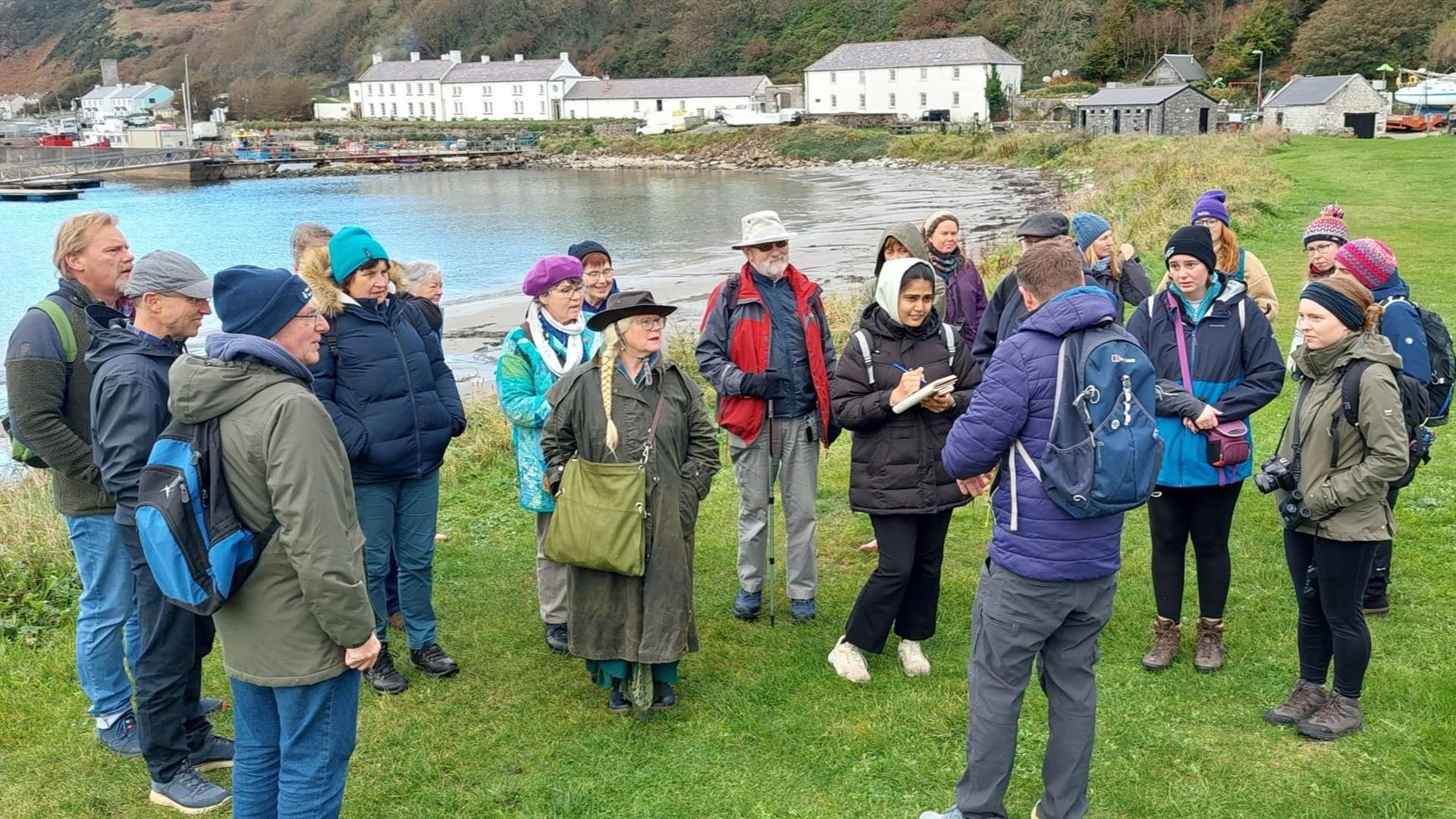 people gather outside on Rathlin Island listening to a tour guide people gather outside on Rathlin Island listening to a tour guide