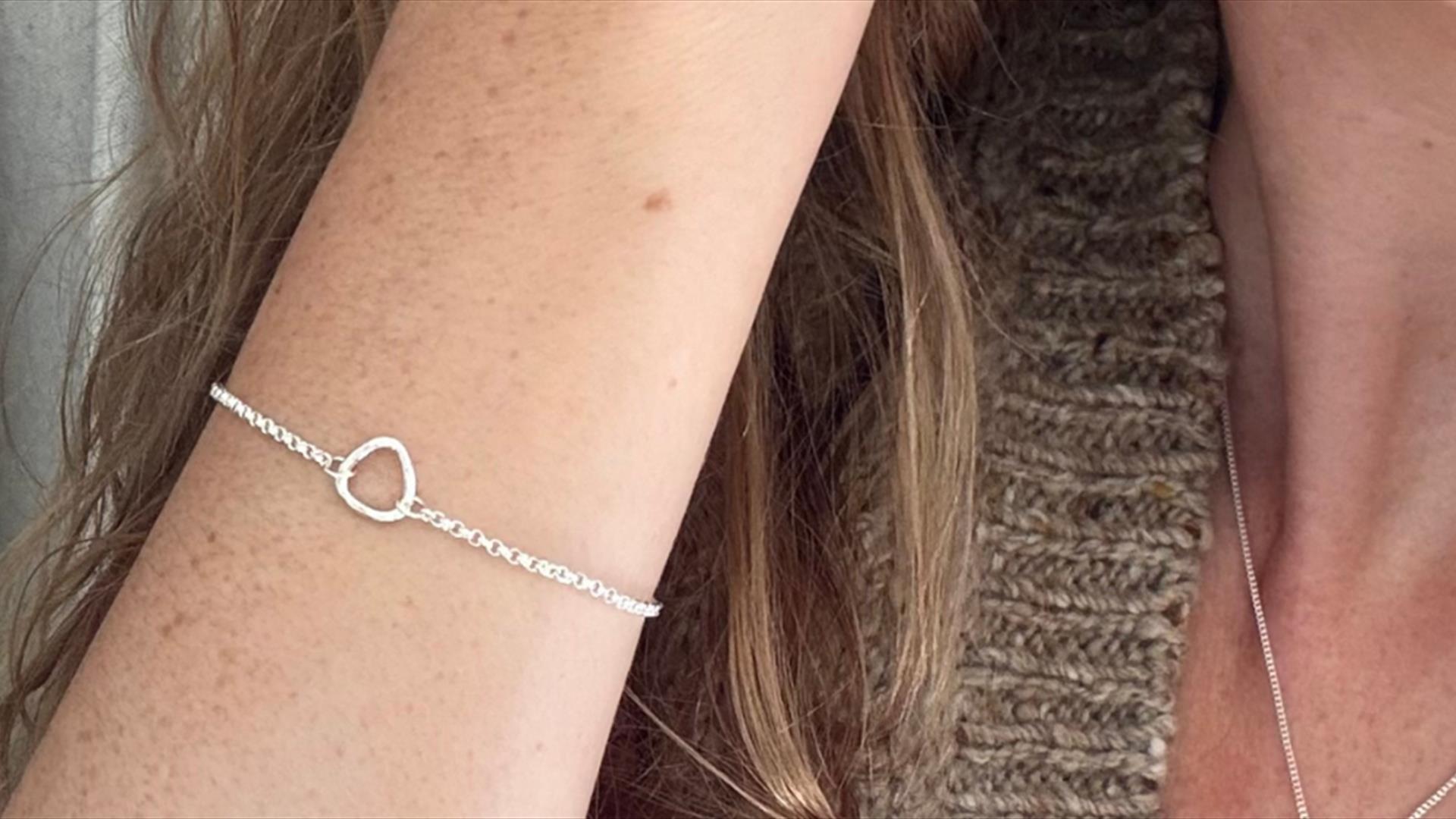 a silver bracelet on a woman's arm a silver bracelet on a woman's arm
