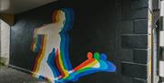 mural of a hurling player with an RGB-style outline