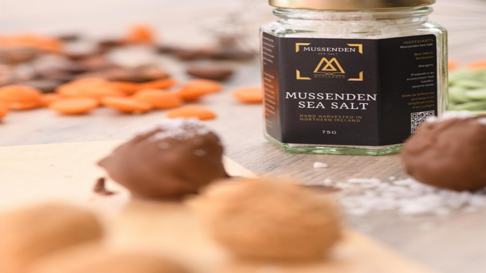 Handmade chocolates in the foreground with a jar of Mussenden Sea Salt in the background