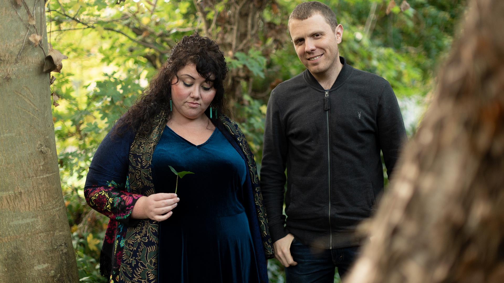 image of Ríoghnach Connolly and Stuart McCallum  outdoors in a forest.