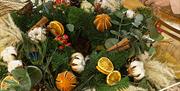 Wreath making with pampas grasses, dried citrus fruits and giant cinnamon sticks