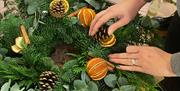 Wreath making materials- pine cones; dried citrus fruits;  large cinnamon sticks