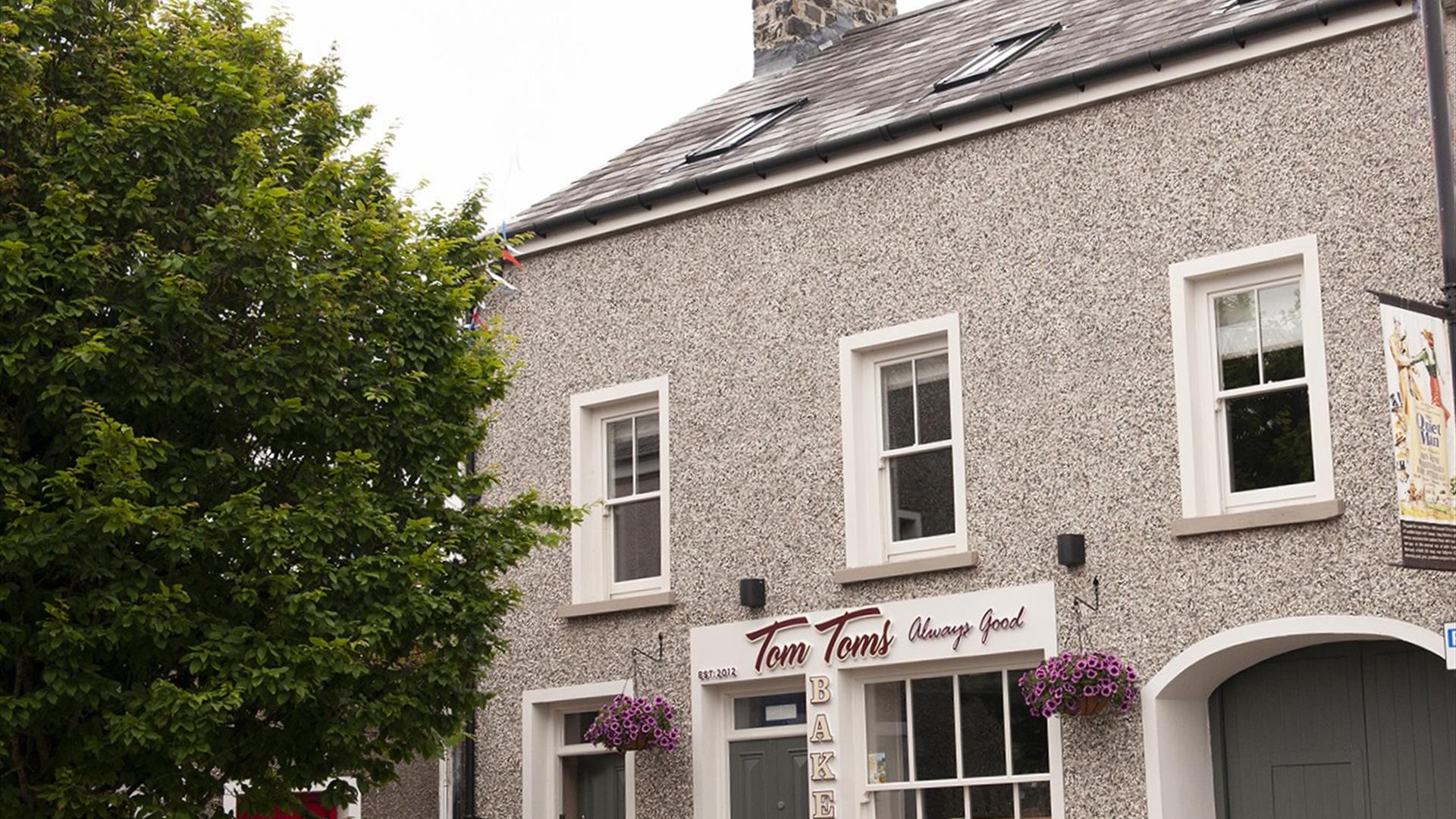 Causeway Squarings frontage showing entrance door beside Tom Tom's Bakery Causeway Squarings frontage showing entrance door beside Tom Tom's Bakery