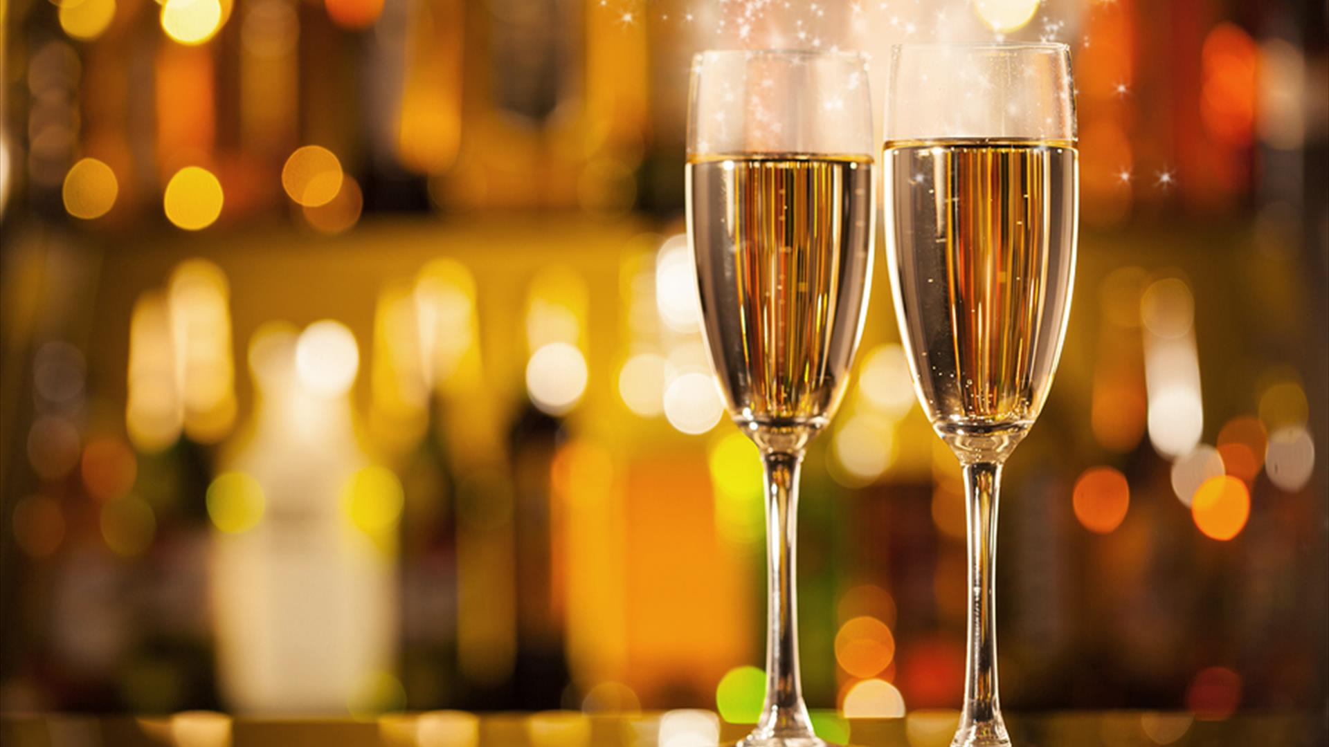 A pair of champagne glasses with sparkles A pair of champagne glasses with sparkles