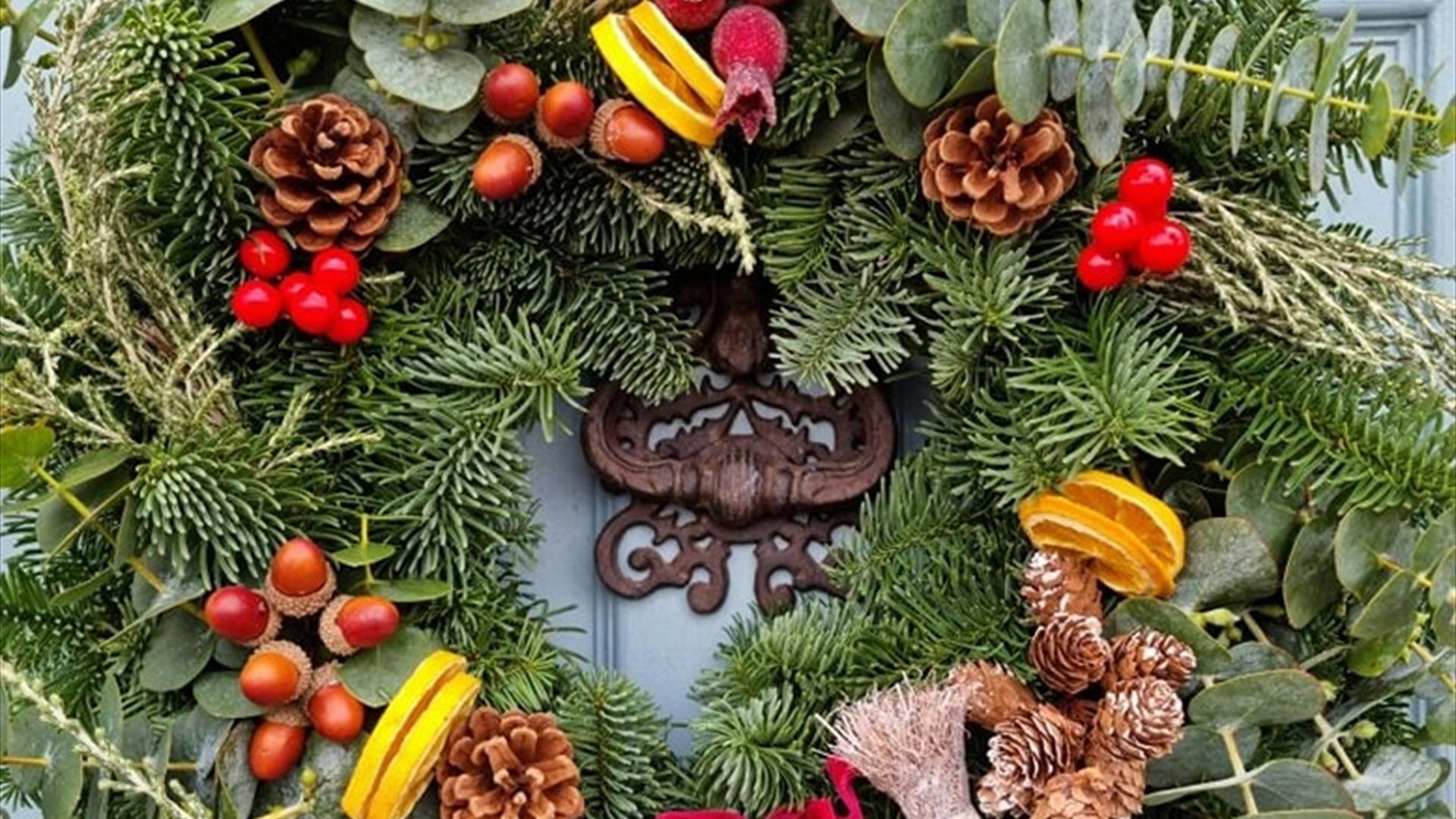 Christmas Wreath with pine cones and a red ribbon