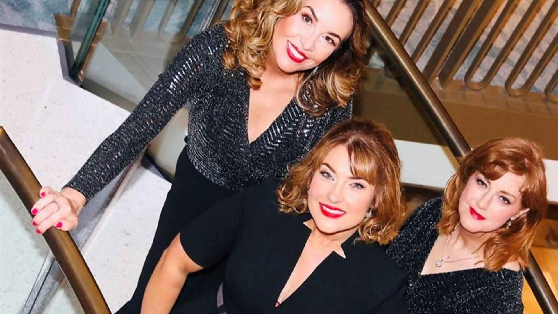 the three members of the band Leading Ladies stand dressed in glitzy black outfits on a staircase the three members of the band Leading Ladies stand dressed in glitzy black outfits on a staircase
