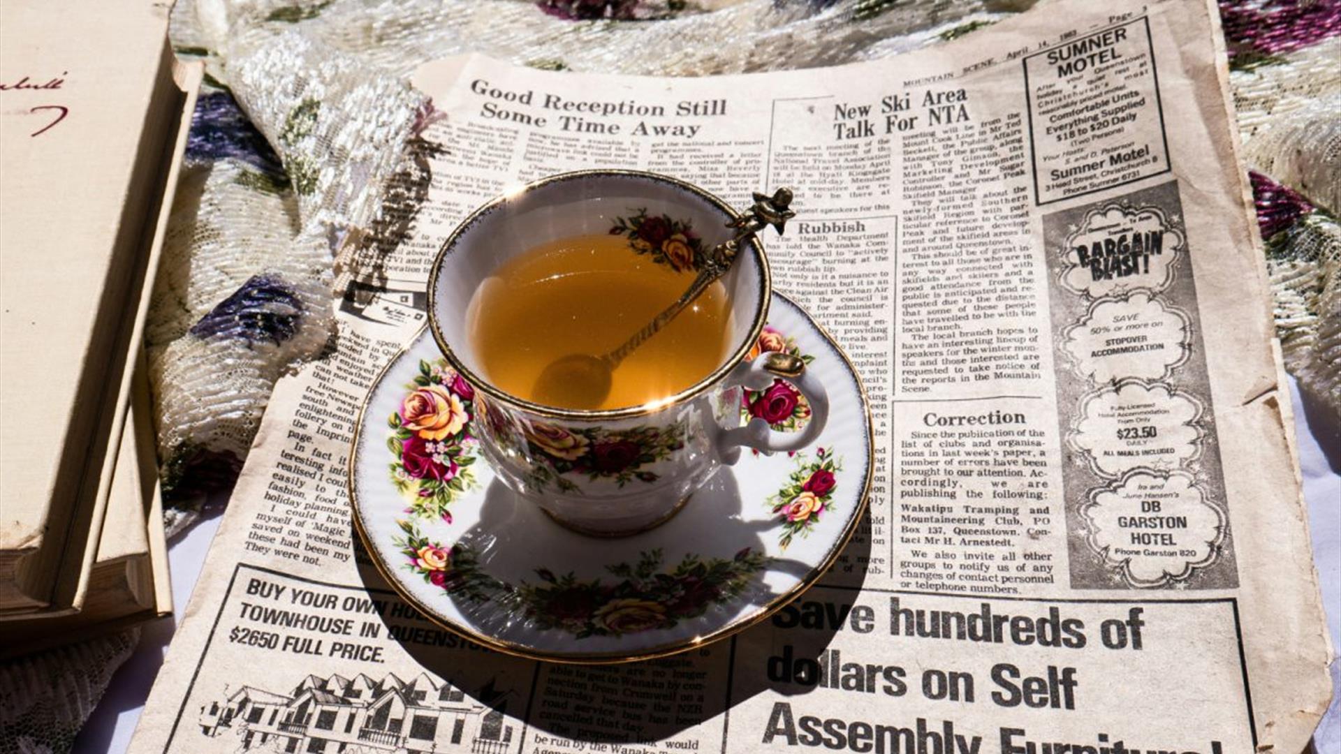 a teacup sitting on top of a newspaper a teacup sitting on top of a newspaper