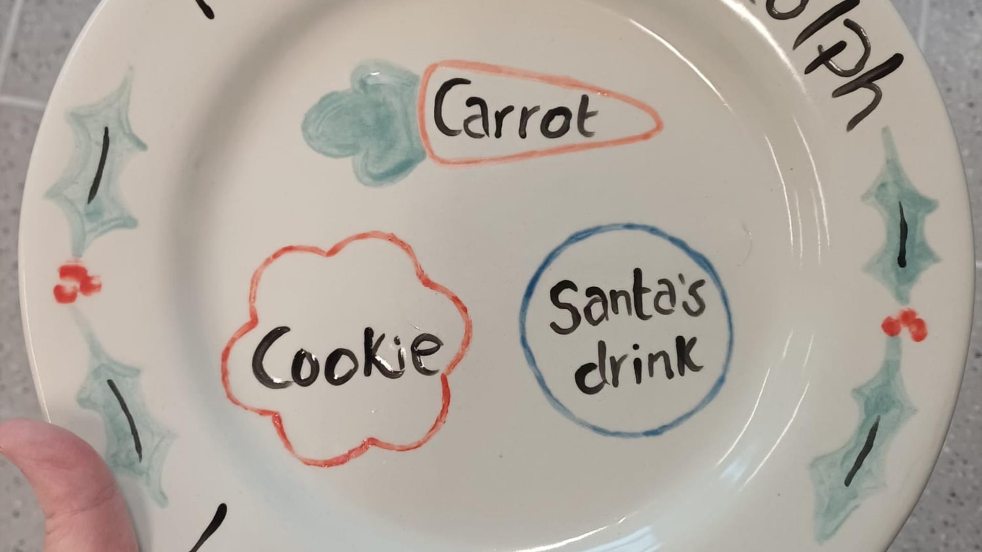 a dinner plate with hand painted spaces for santa's drink and cookie and a carrot for his reindeer. a dinner plate with hand painted spaces for santa's drink and cookie and a carrot for his reindeer.
