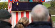 A family watching a Punch & Judy Show