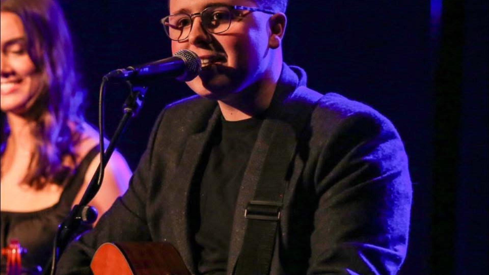 a musician sings into a microphone a musician sings into a microphone
