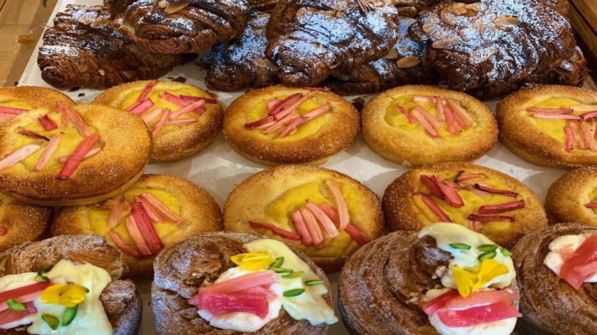 Image of pasteries with brightly coloured garnish on top to finish