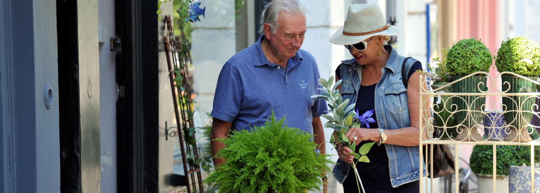 Couple browsing plants and planters outside a shop in Cheltenham