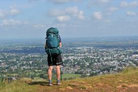 A man overlooking Cheltenham from Leckhampton Hill