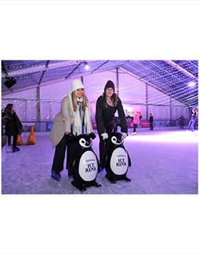 Two women on skate aids at the Cheltenham Ice Rink