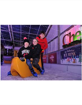 A group of children riding a skate aid at the Cheltenham Ice Rink