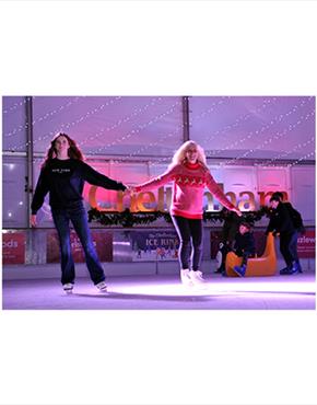 A mother and daughter skating at the Cheltenham Ice Rink