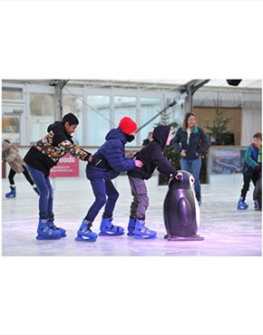 A group of children forming a conga line at the Cheltenham Ice Rink