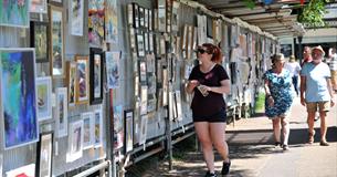 A woman viewing art in Imperial Gardens