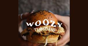 Image of a burger with the text Woozy Tuesdays