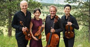 Takacs Quartet stood outside, holding violins and a cello