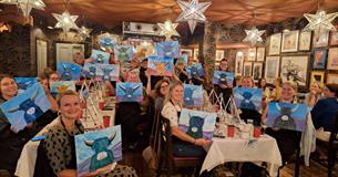 Group of ladies showing their cow paintings