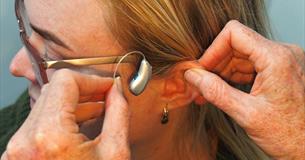 Woman receiving a hearing aid