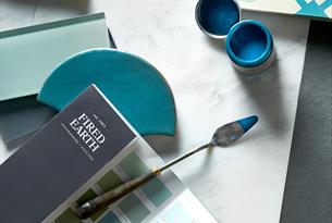 Paint swatch surrounded by colourful house accessories