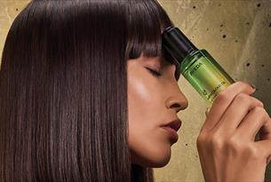 a Model holding an aveda product