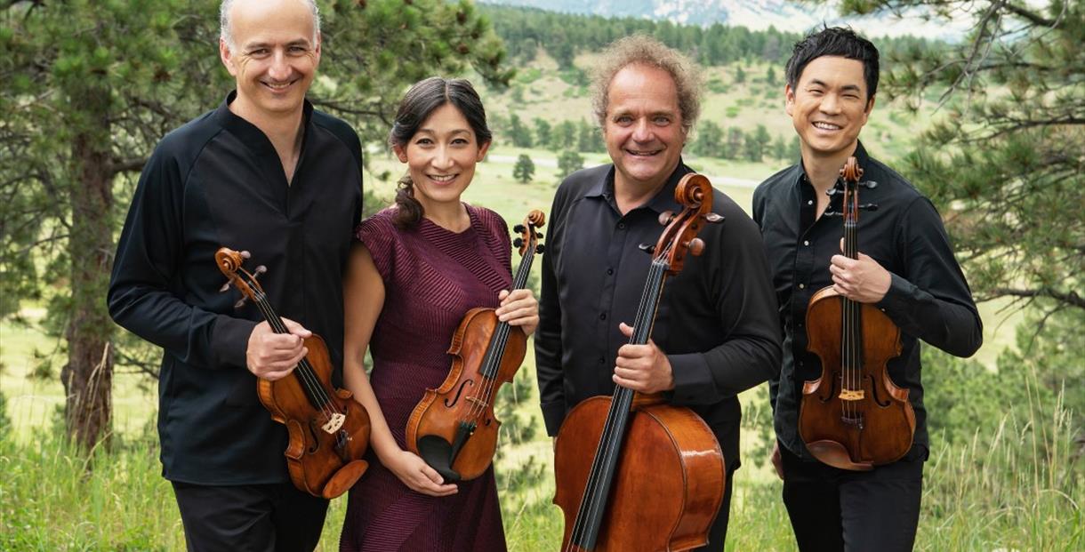 Takacs Quartet stood outside, holding violins and a cello