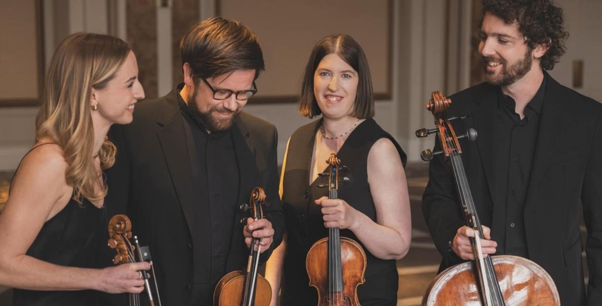 Castalian Quartet in formal black dress holding violins and cellos.
