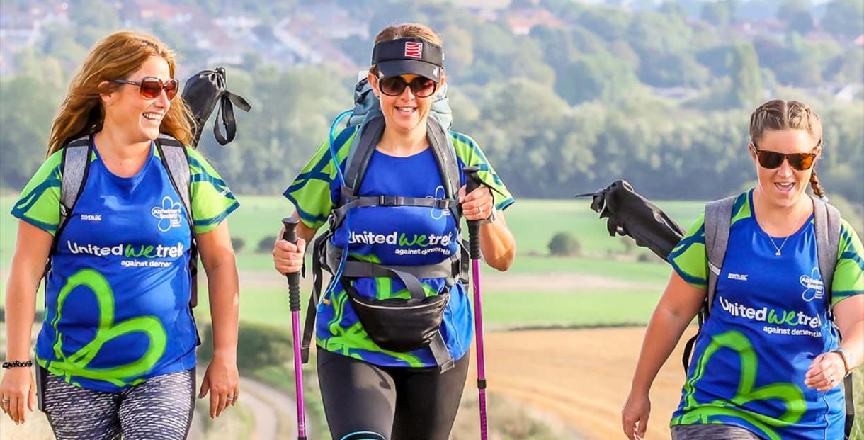 Three female hikers sporting Alzheimers Society tshirts