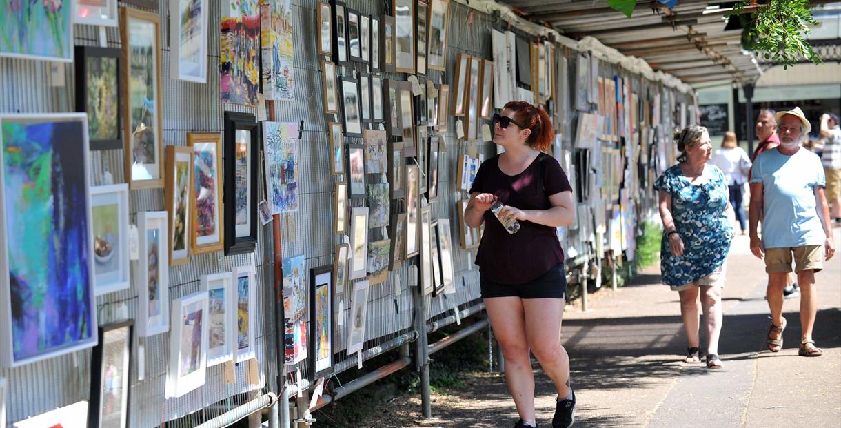 A woman viewing art in Imperial Gardens