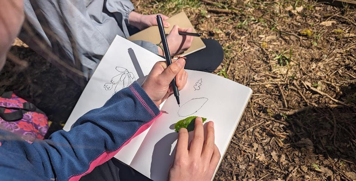 Person drawing outdoors