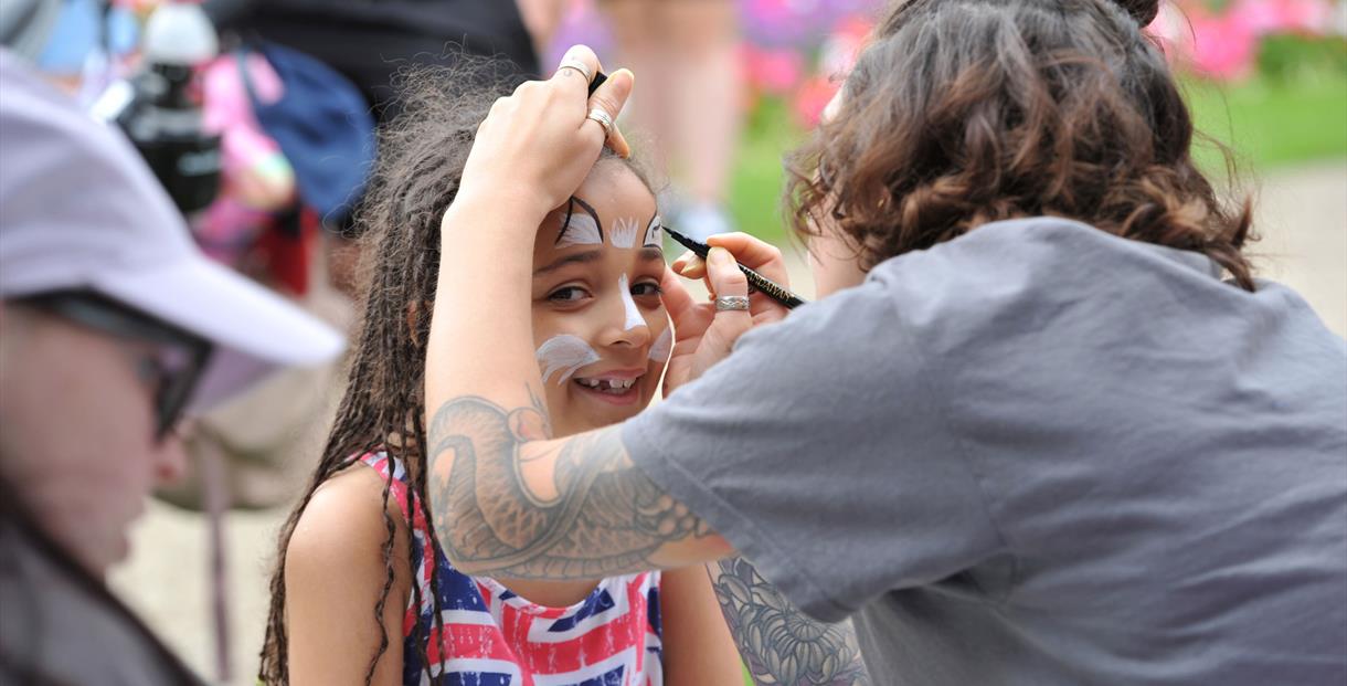 A child having her face painted.