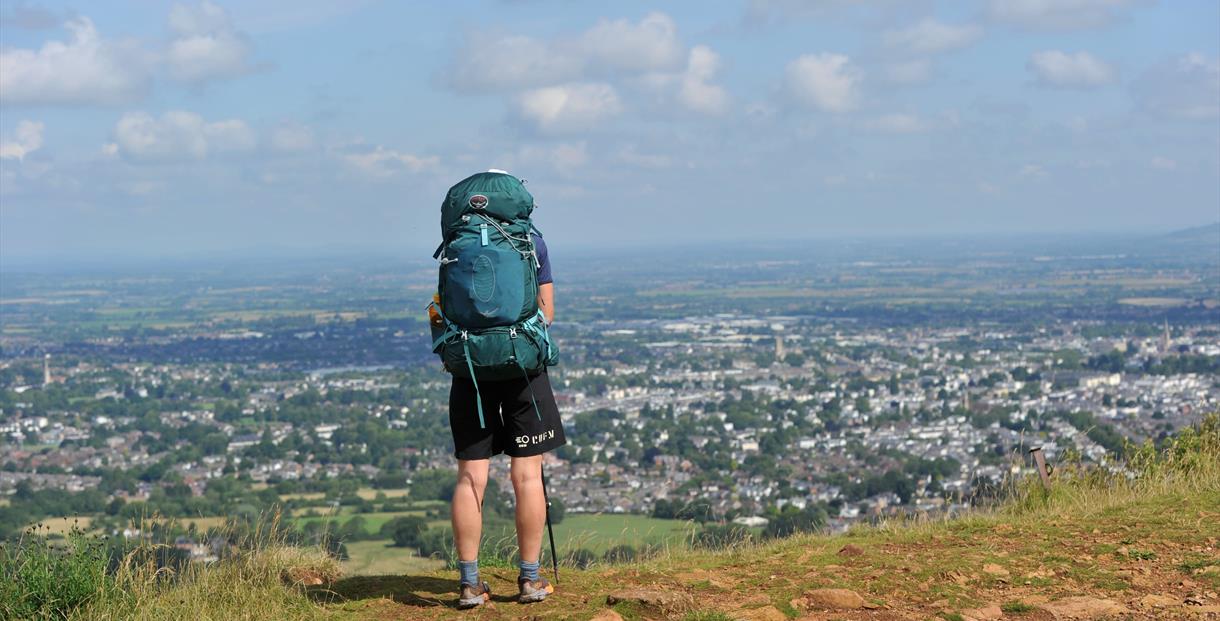 A man overlooking Cheltenham from Leckhampton Hill