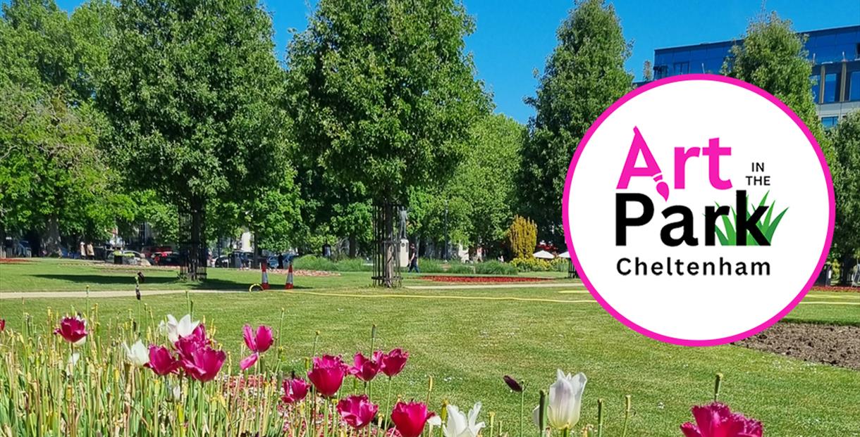 A photo of the imperial gardens park where art in the park will take place showing white and pink tulips in the foreground, tall green trees against a