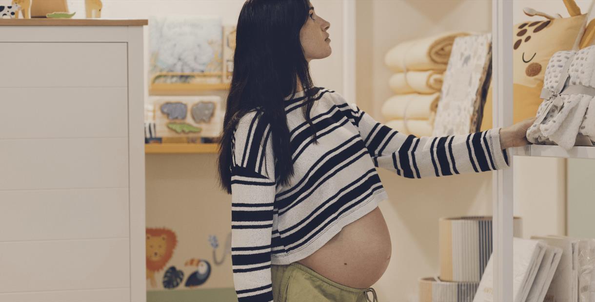 Pregnant person looking at shelves
