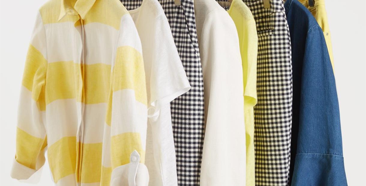 Selection of colourful clothes hanging on a rack