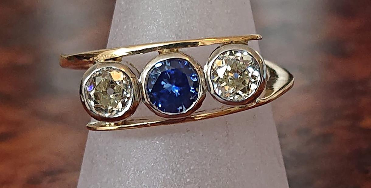Gold ring with 3 large sparkling gemstones