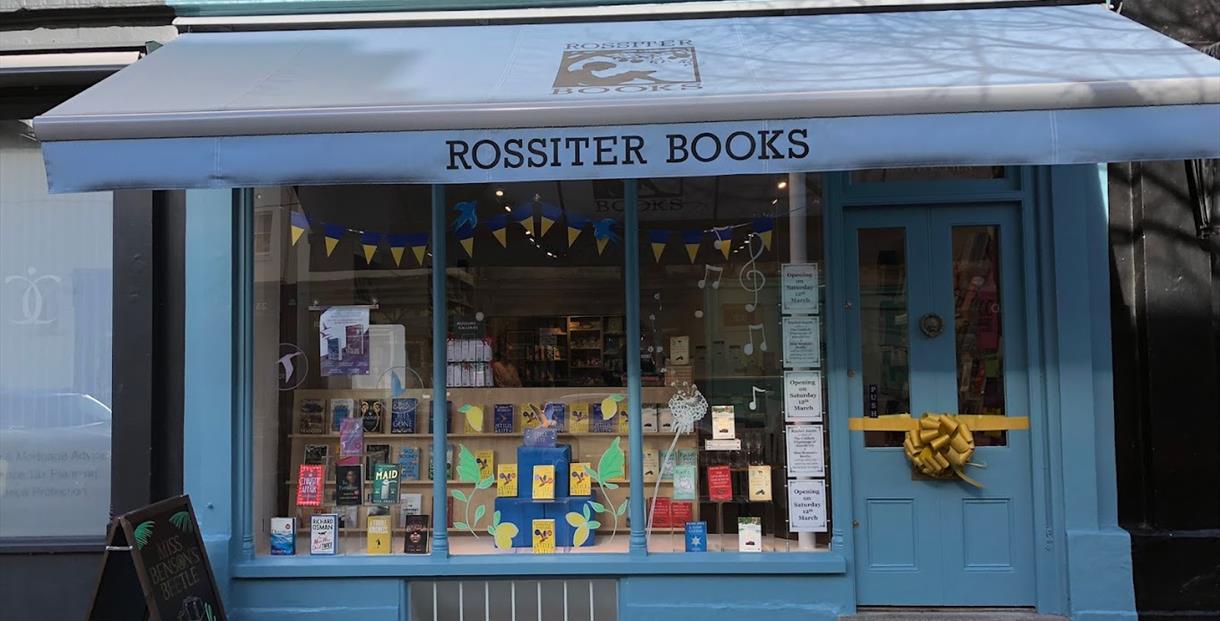 Traditional shop from of Rossiter Books with large window and awning