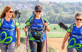 Three female hikers sporting Alzheimers Society tshirts