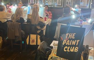 A group of people painting with The Paint Club