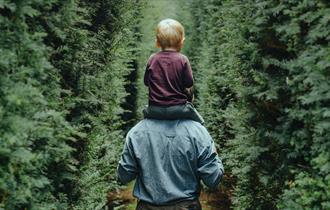 Child sat on father's shoulders